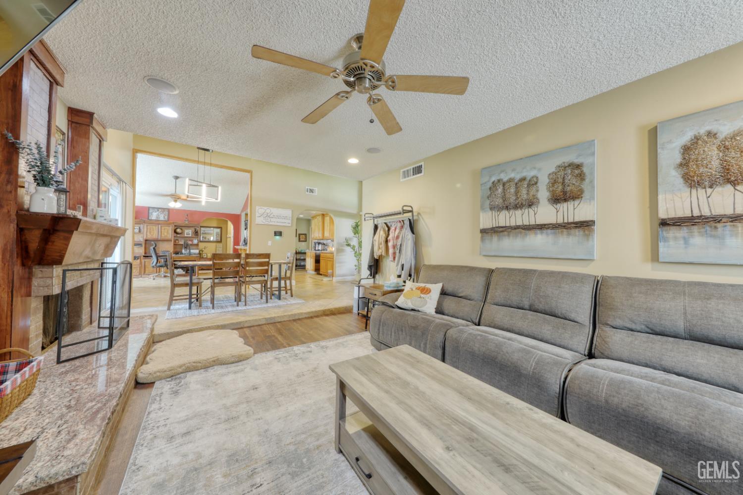 Undisclosed Address Bakersfield, CA 93308 - Photo 13 of 64 a living room with furniture and a flat screen tv