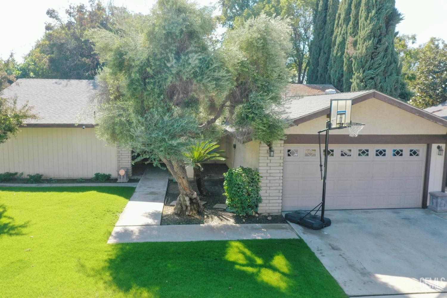 Undisclosed Address Bakersfield, CA 93308 - Photo 2 of 64 a view of a house with a yard garage and tree