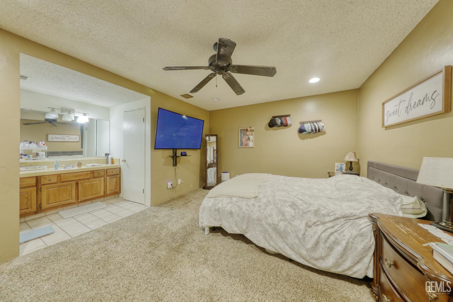 Undisclosed Address Bakersfield, CA 93308 - Photo 28 of 64 a spacious bedroom with a bed and ceiling fan