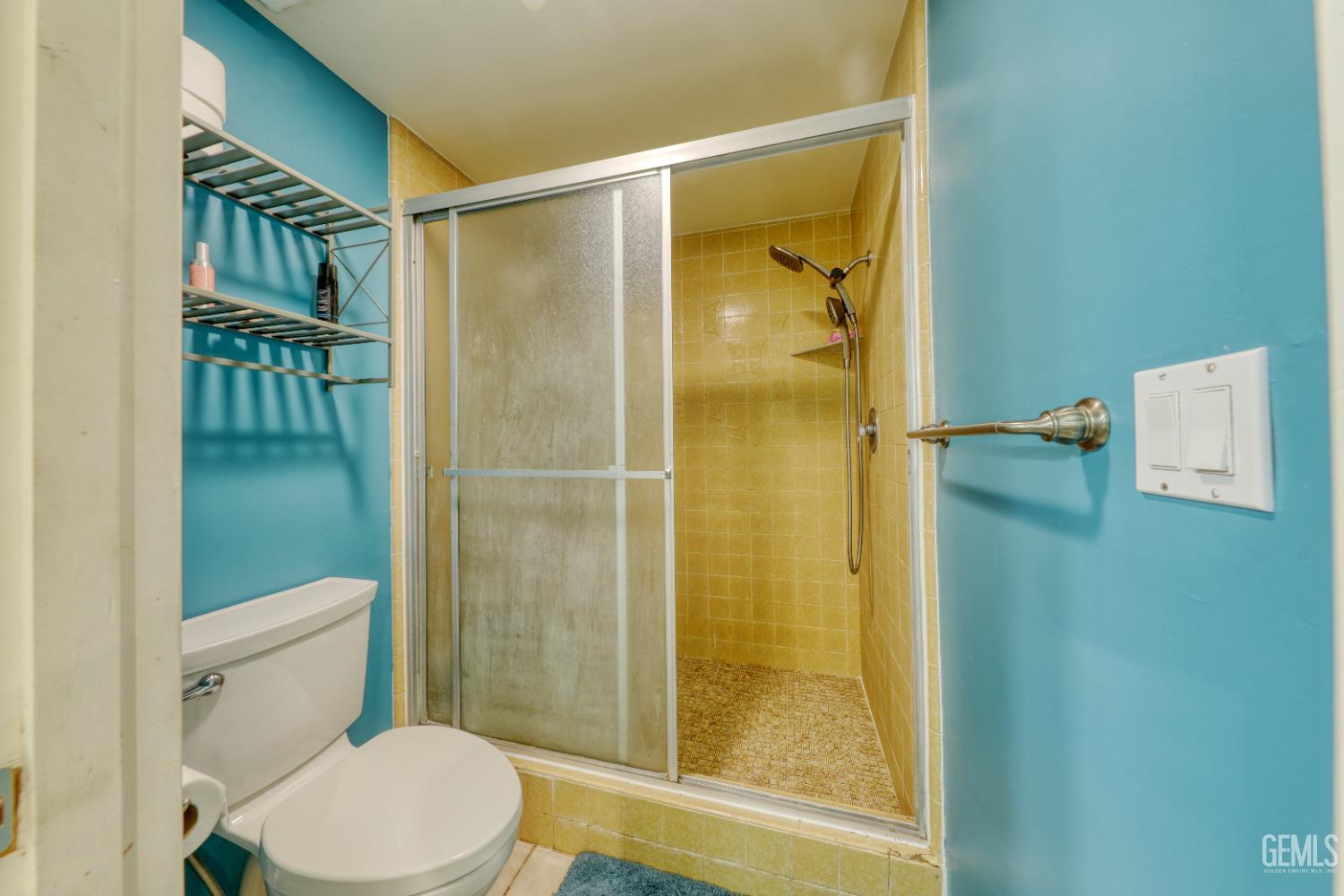Undisclosed Address Bakersfield, CA 93308 - Photo 30 of 64 a bathroom with a shower and toilet