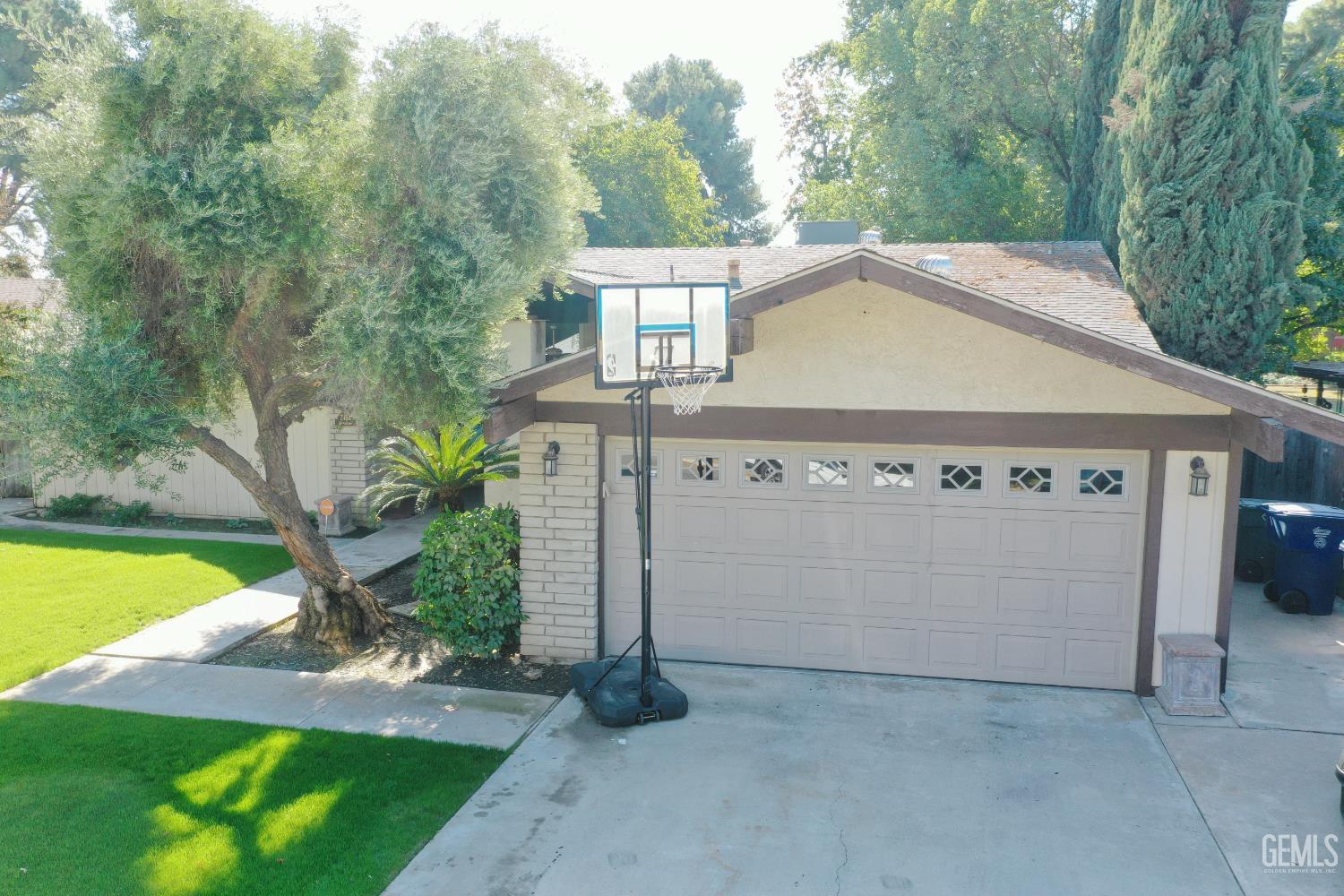 Undisclosed Address Bakersfield, CA 93308 - Photo 3 of 64 a view of a house with backyard and a garden