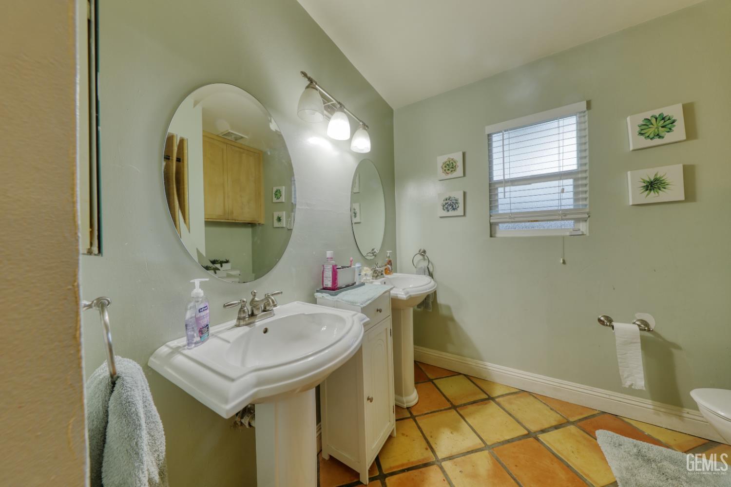 Undisclosed Address Bakersfield, CA 93308 - Photo 39 of 64 a bathroom with a sink and a mirror