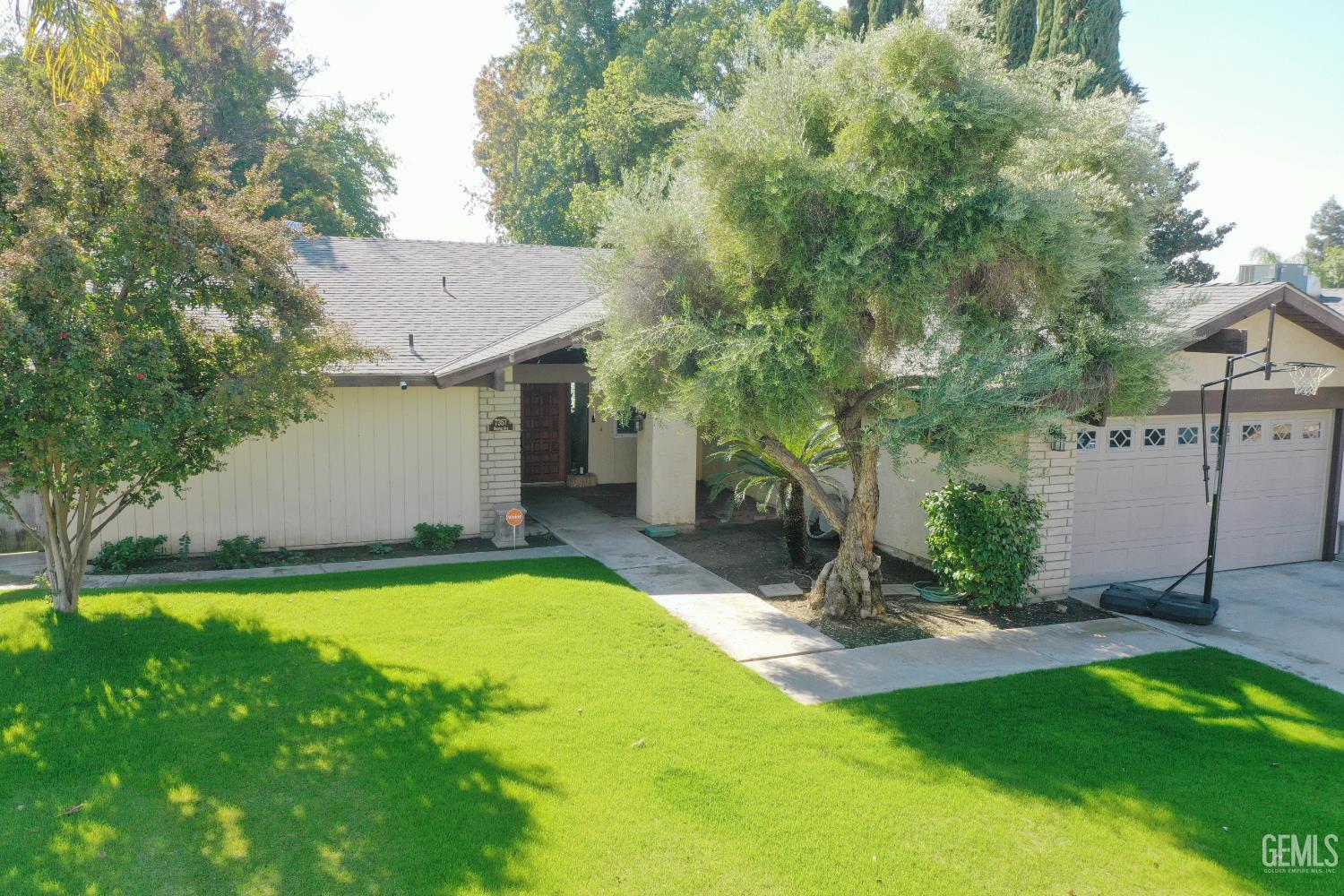 Undisclosed Address Bakersfield, CA 93308 - Photo 4 of 64 a view of a backyard with plants and a patio