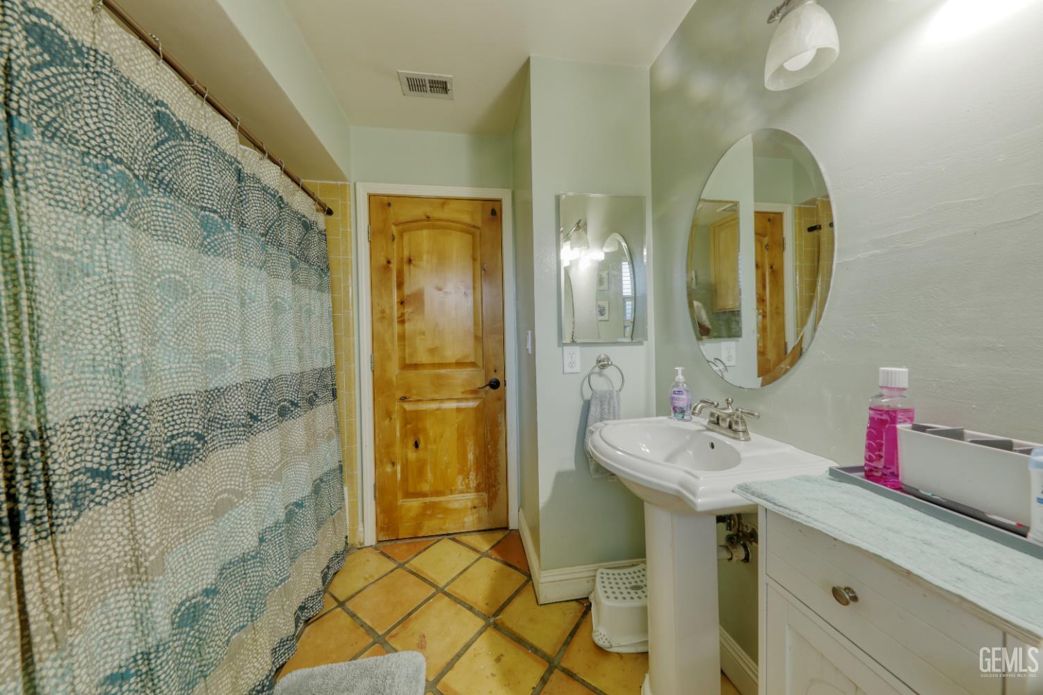 Undisclosed Address Bakersfield, CA 93308 - Photo 41 of 64 a bathroom with a sink and a mirror
