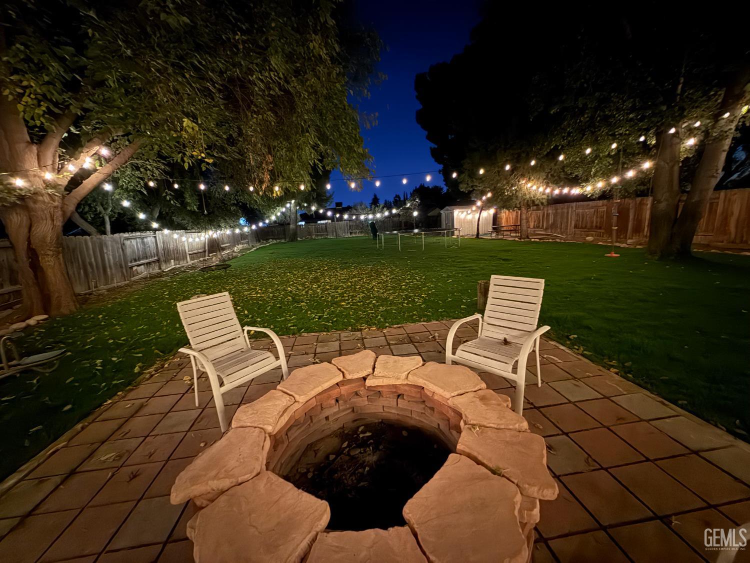 Undisclosed Address Bakersfield, CA 93308 - Photo 47 of 64 a view of a table and chairs in backyard of the house