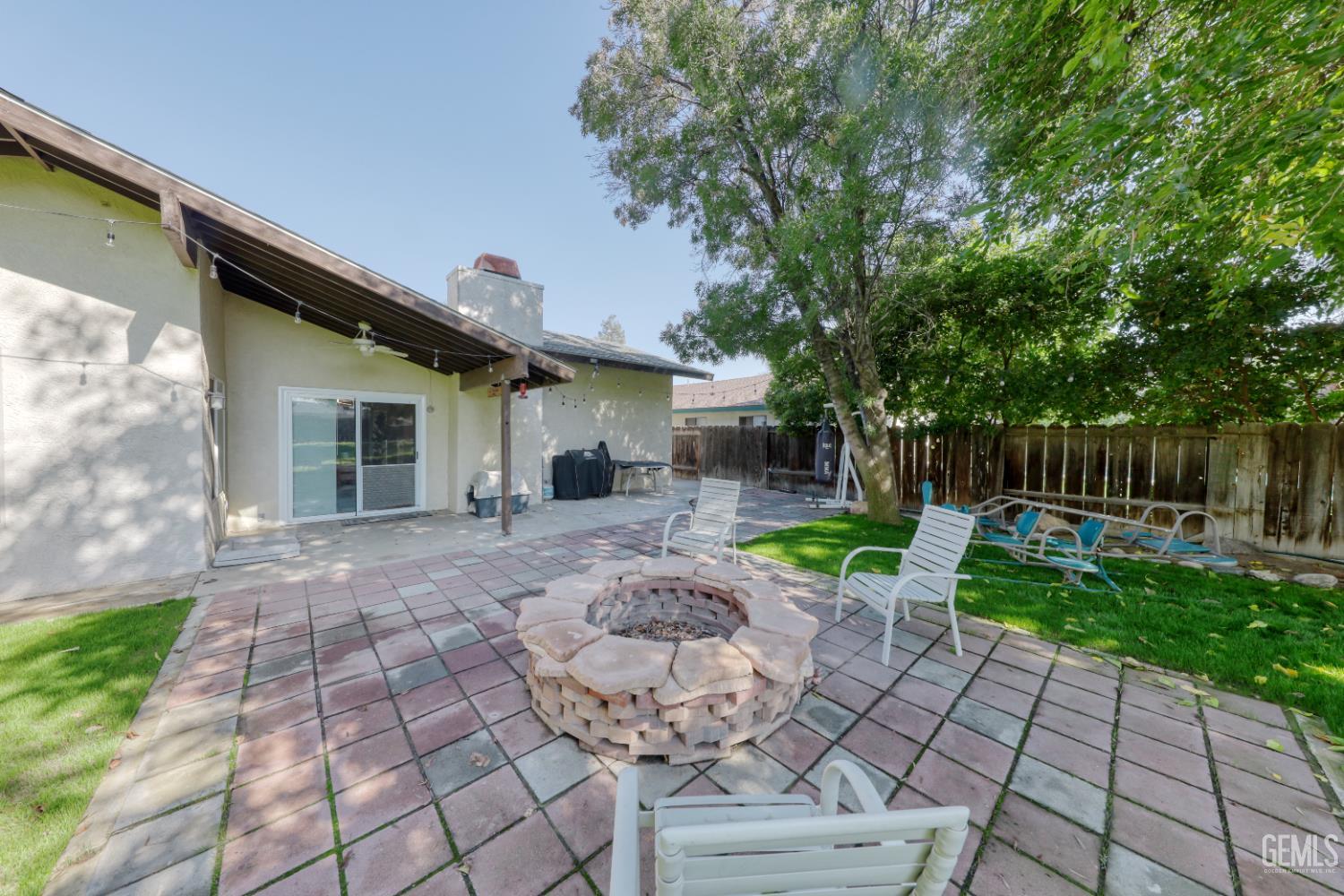 Undisclosed Address Bakersfield, CA 93308 - Photo 52 of 64 a view of a chair and table in backyard of the house