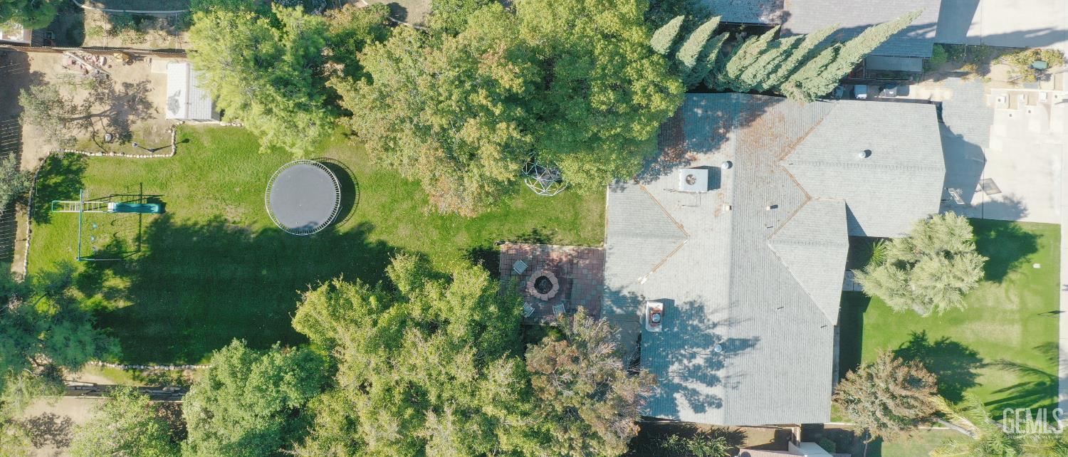 Undisclosed Address Bakersfield, CA 93308 - Photo 58 of 64 an aerial view of a house with a yard and a large tree