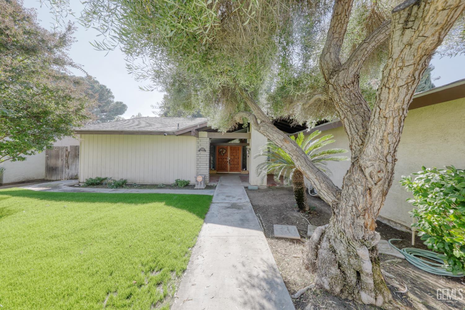 Undisclosed Address Bakersfield, CA 93308 - Photo 6 of 64 a front view of a house with garden