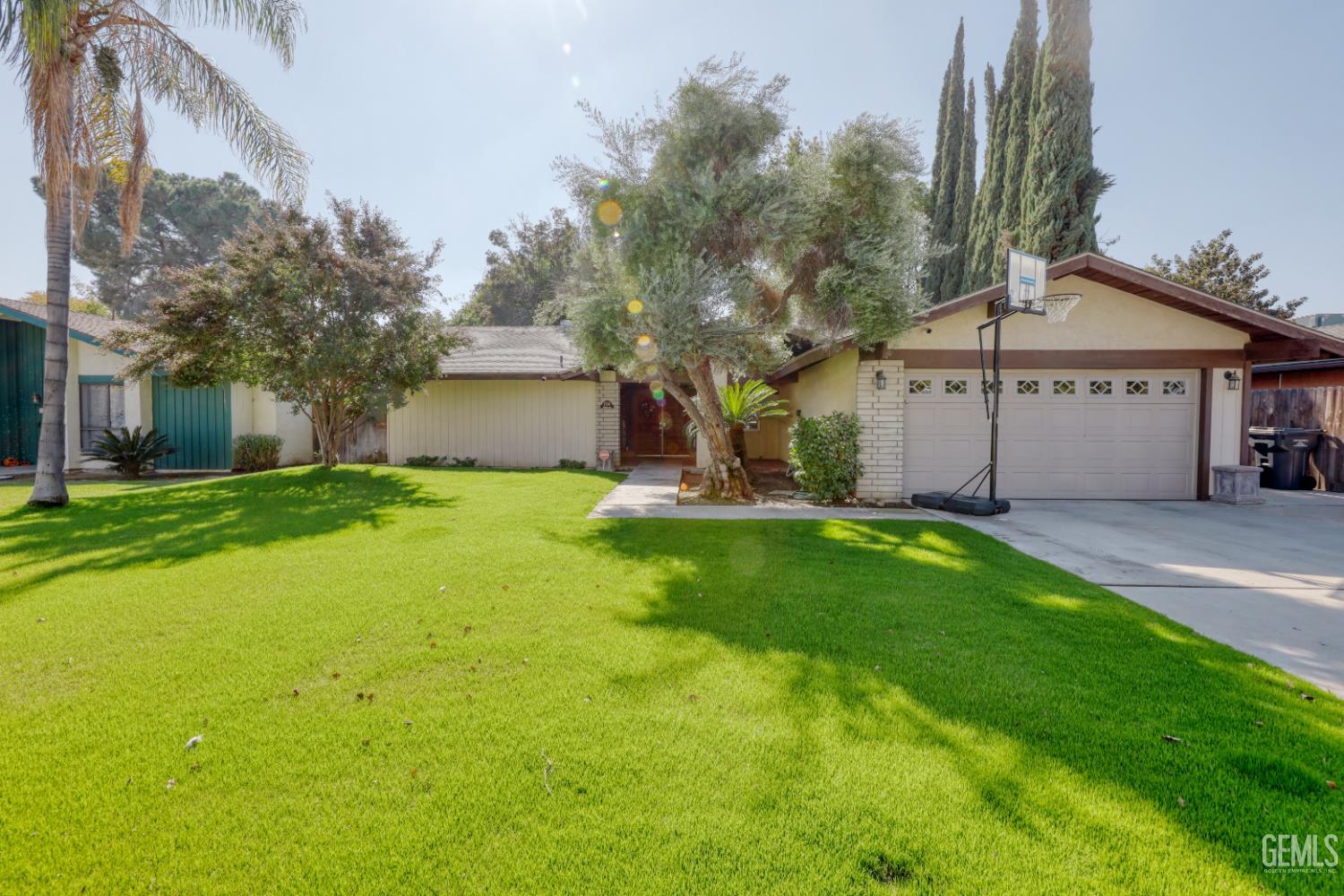 Undisclosed Address Bakersfield, CA 93308 - Photo 61 of 64 a view of a house with a big yard and large tree