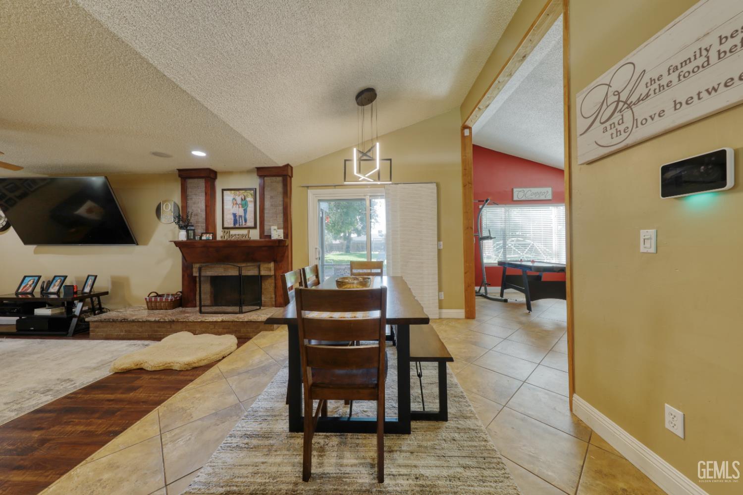 Undisclosed Address Bakersfield, CA 93308 - Photo 10 of 64 a living room with furniture a fireplace and a flat screen tv
