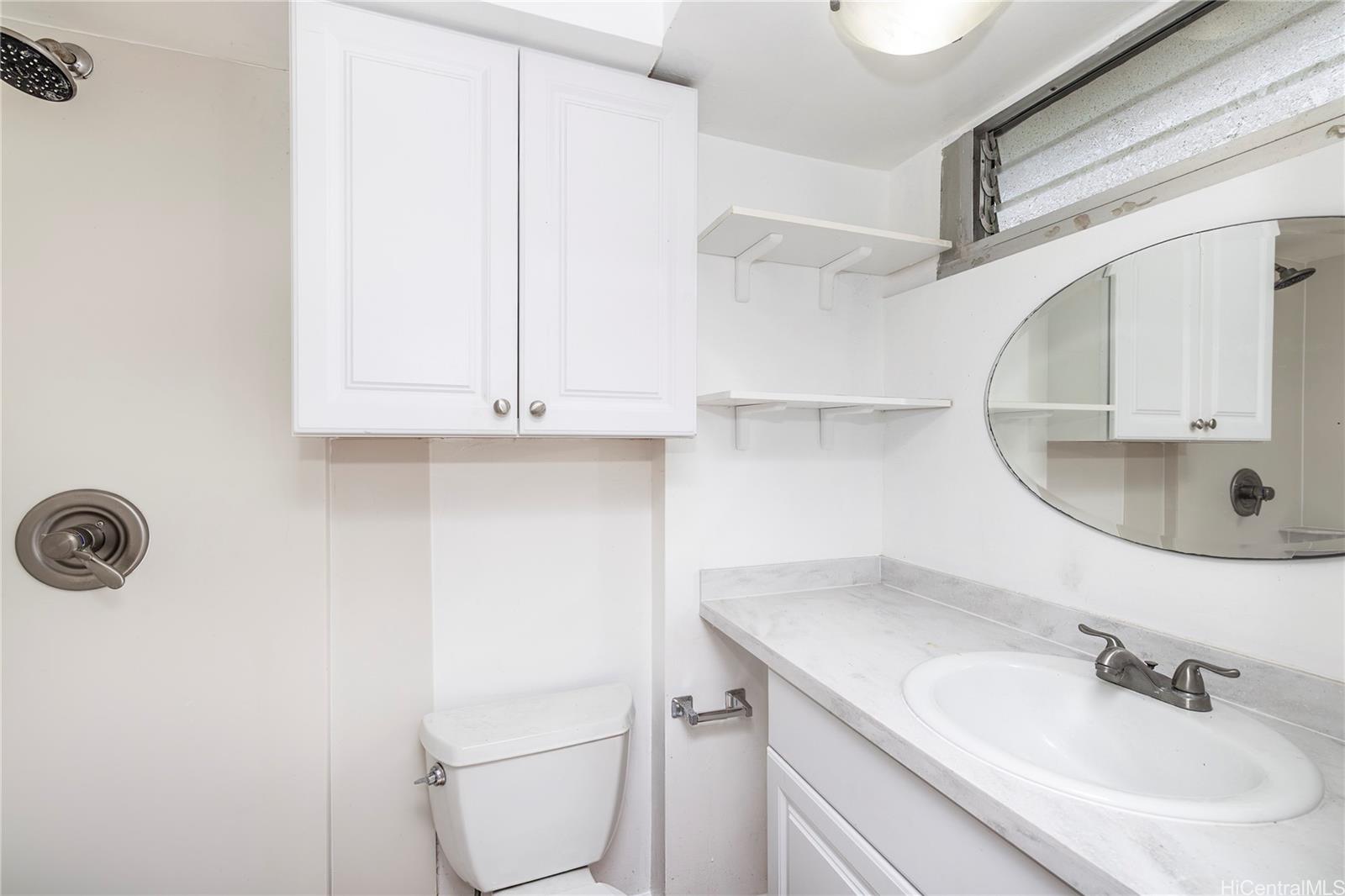 2888 Ala Ilima Street, Unit 1901 Honolulu, HI 96818 - Photo 5 of 14 a bathroom with a sink and mirror