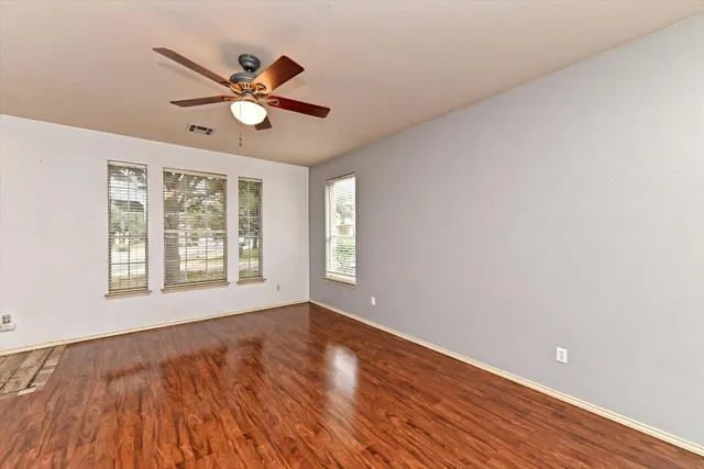 a view of a dining room with furniture wooden floor and chandelier