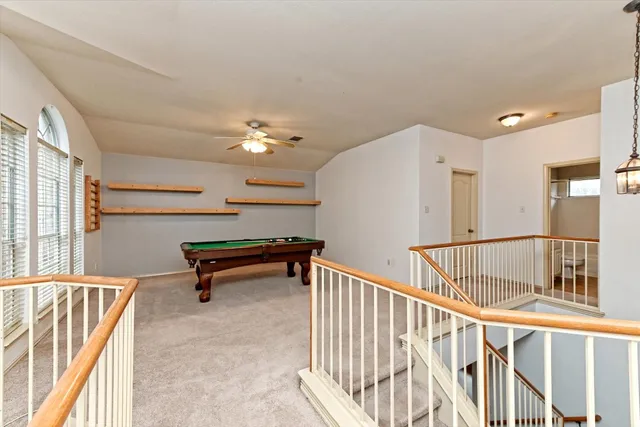 a room with pool table and windows