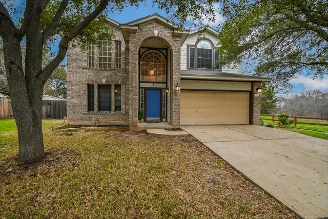 a front view of house with yard and green space