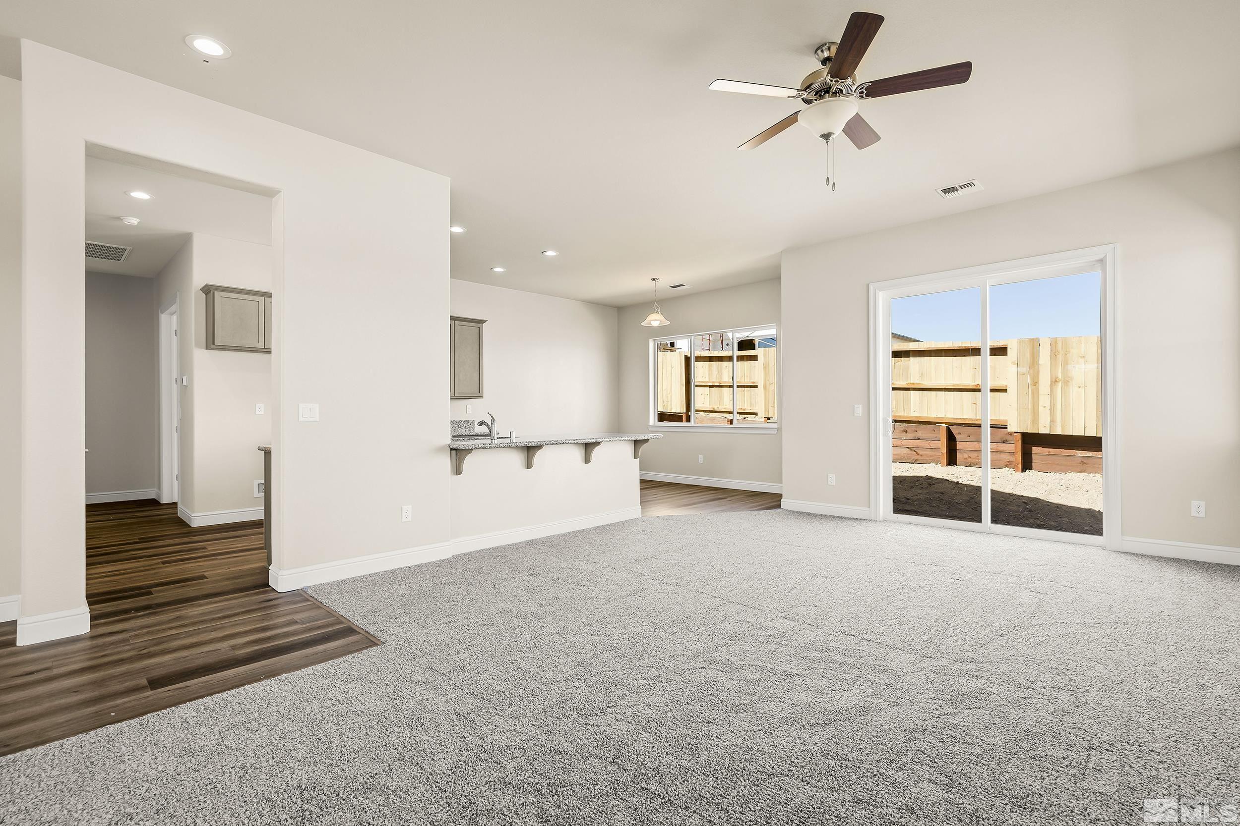 11048 Athabasca Drive Reno, NV 89506 - Photo 11 of 16 a view of a livingroom with wooden floor and a ceiling fan