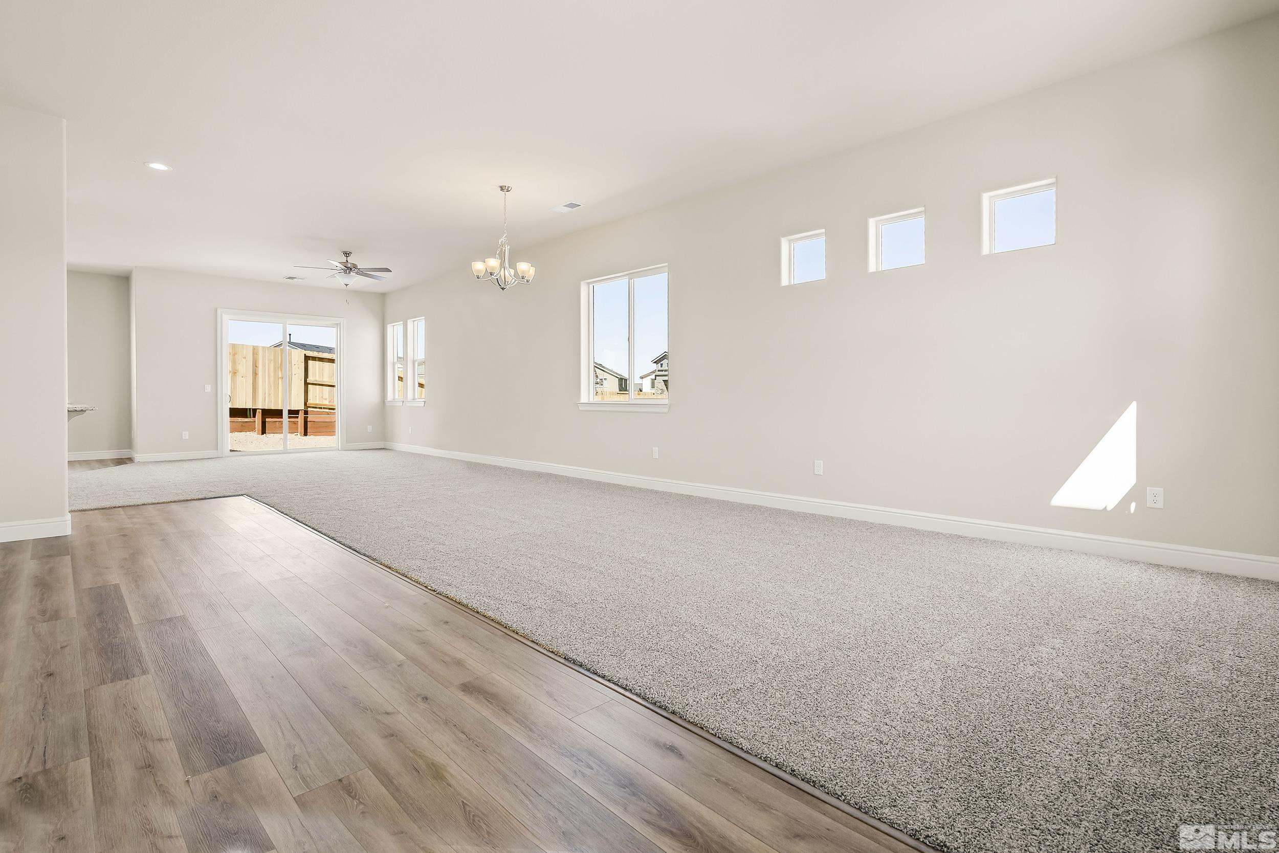 11048 Athabasca Drive Reno, NV 89506 - Photo 12 of 16 an empty room with wooden floor and windows
