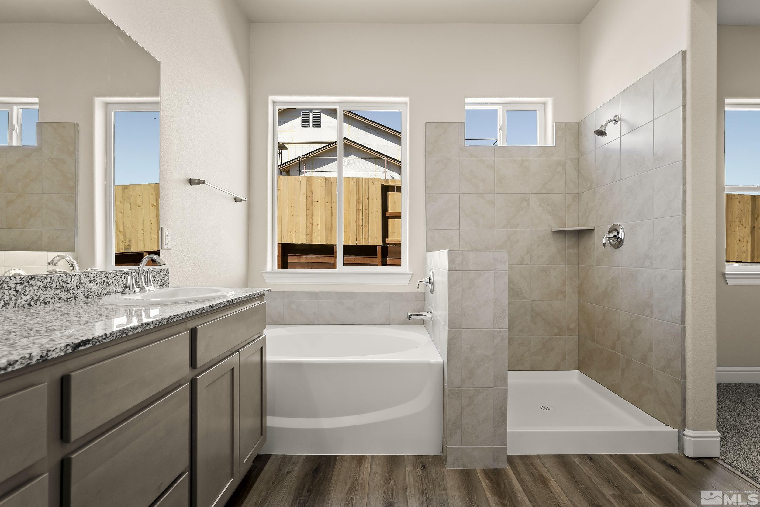 11048 Athabasca Drive Reno, NV 89506 - Photo 13 of 16 a bathroom with a tub sink and mirror