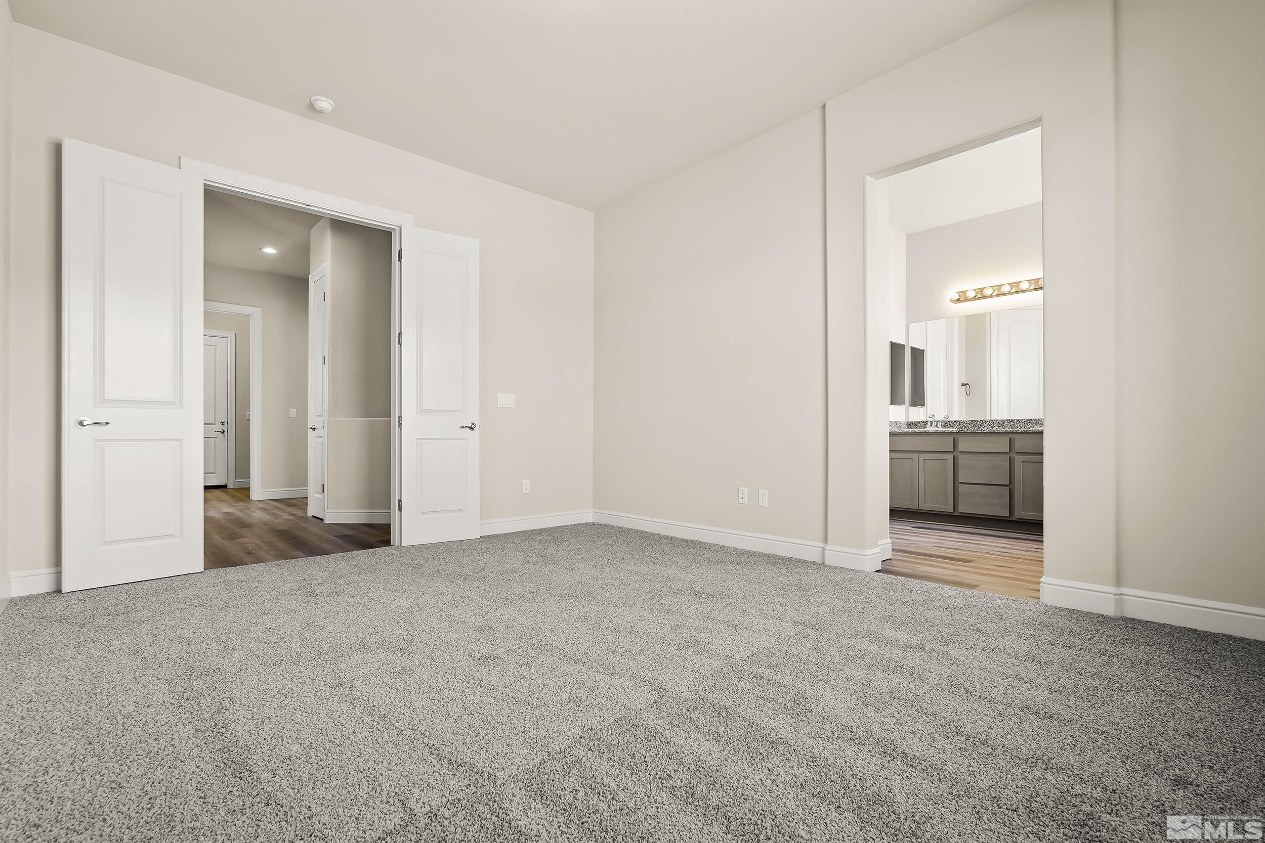 11048 Athabasca Drive Reno, NV 89506 - Photo 15 of 16 an empty room with a bathroom and mirror