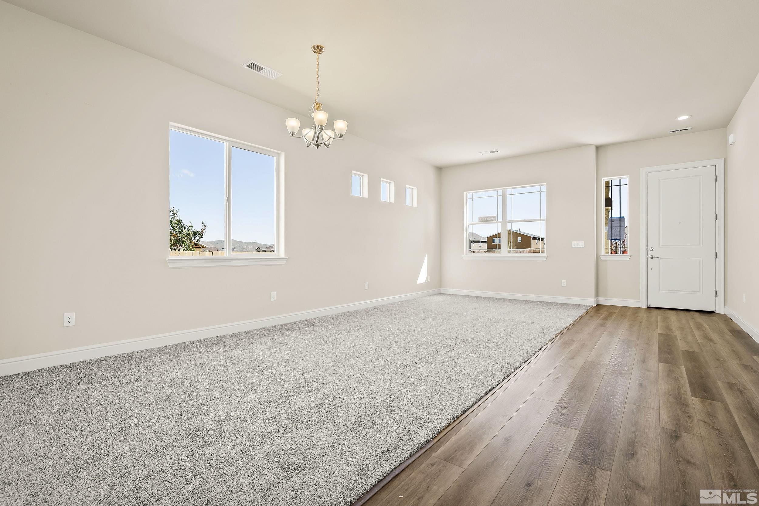 11048 Athabasca Drive Reno, NV 89506 - Photo 9 of 16 a view of empty room with wooden floor and window