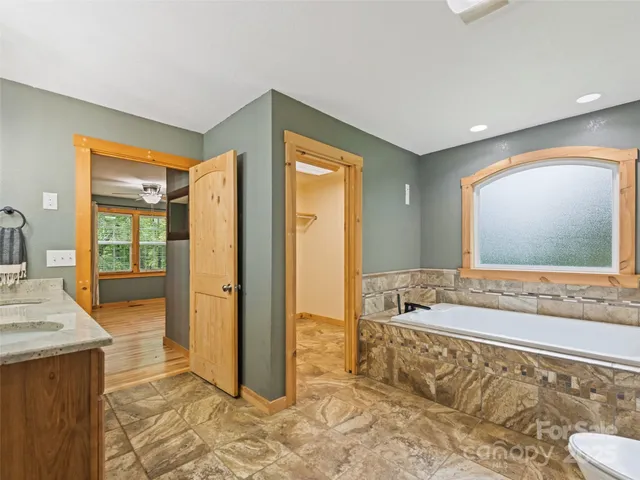 a bathroom with a tub shower and sink