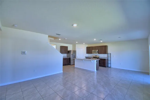 a living room with furniture and kitchen