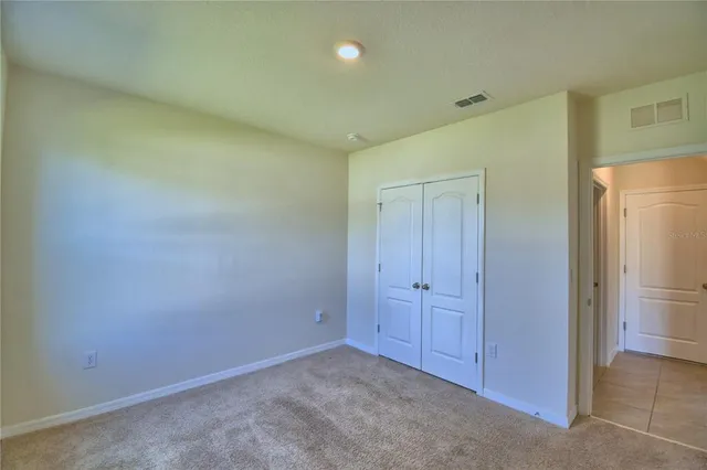 an empty room with closet area
