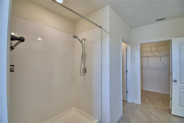 a bathroom with a shower and a glass door