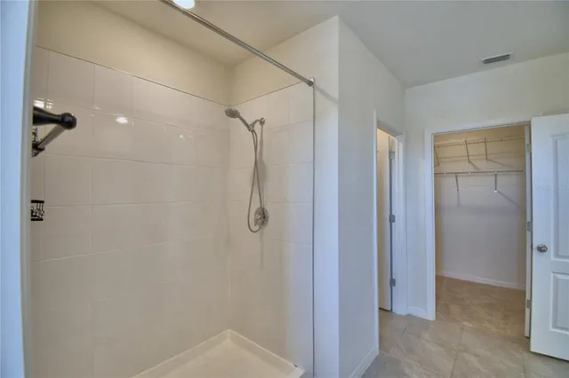 a bathroom with a shower and a glass door