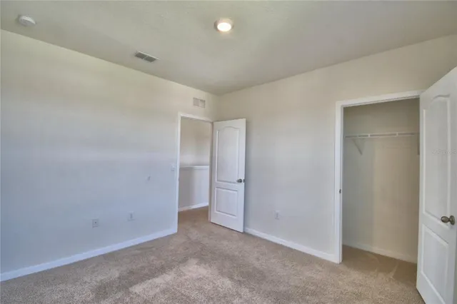 an empty room with a bench and a sink