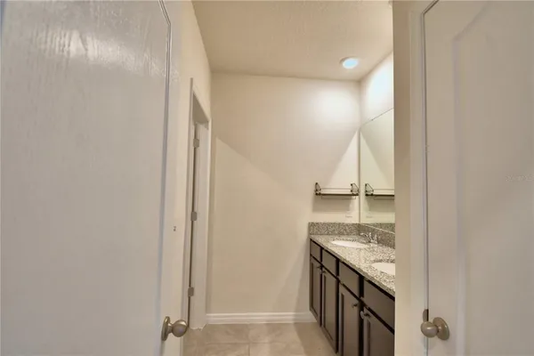 a bathroom with a granite countertop sink and a stove