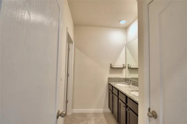 a bathroom with a granite countertop sink and a stove
