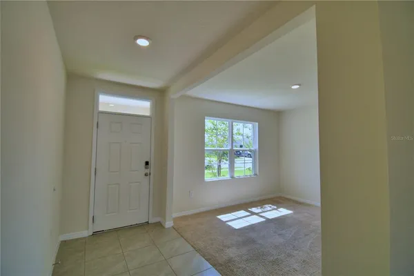 a view of an empty room and a window