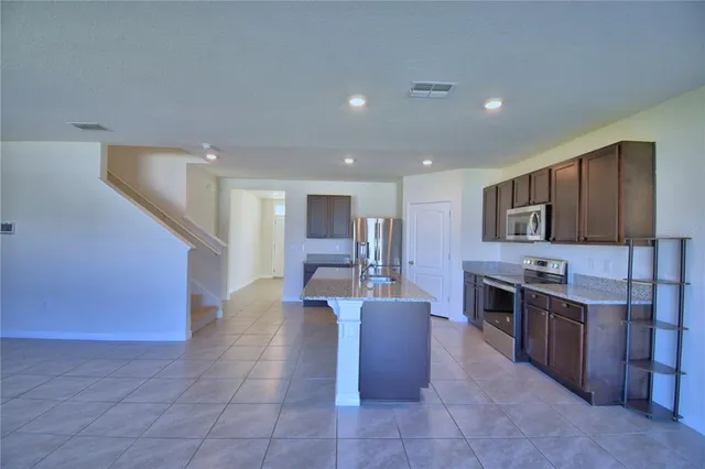 a large kitchen with stainless steel appliances lots of counter top space