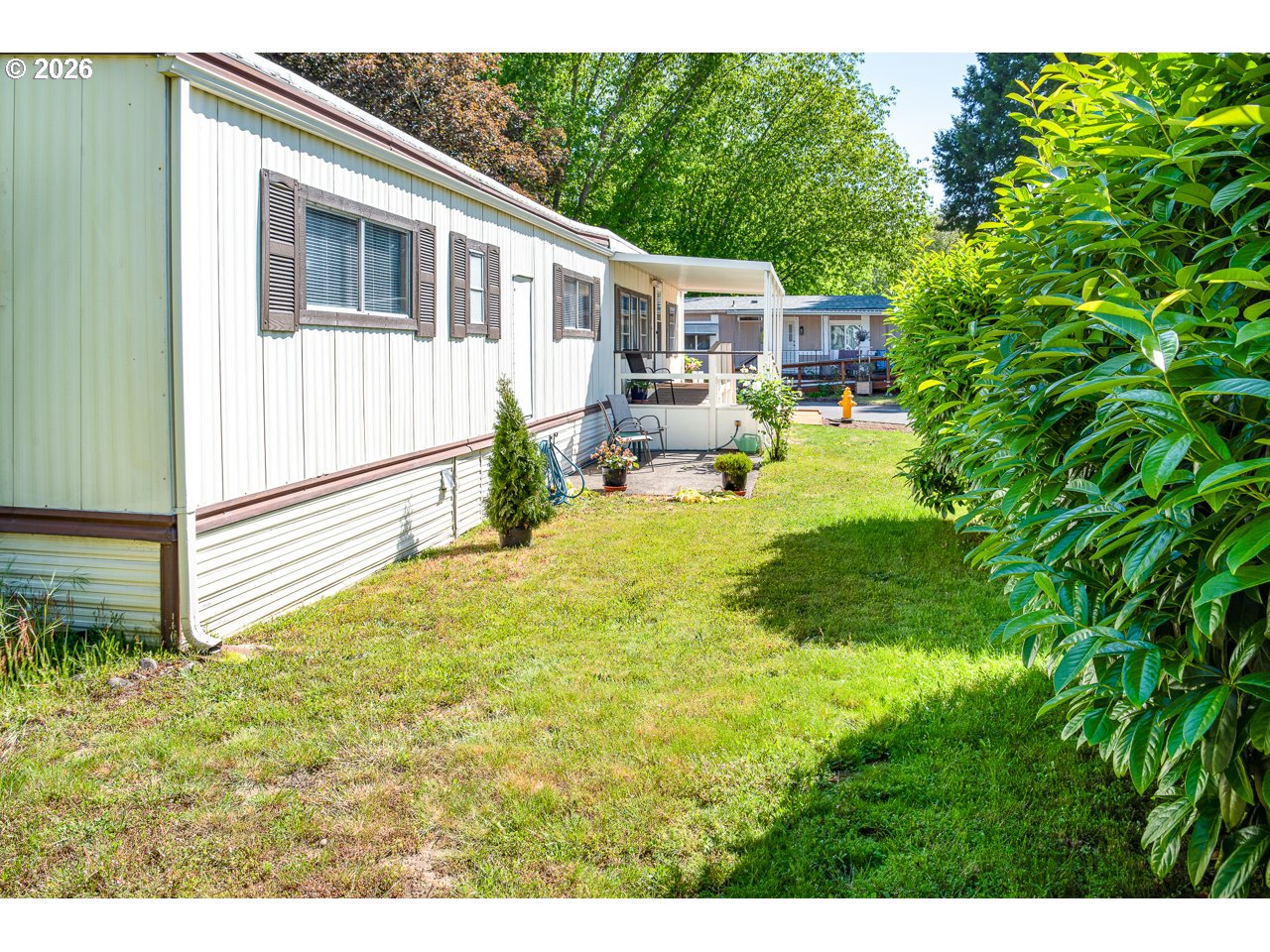 1475 Green Acres Road, Unit 172 Eugene, OR 97408 - Photo 34 of 35 a view of a house with backyard and sitting area