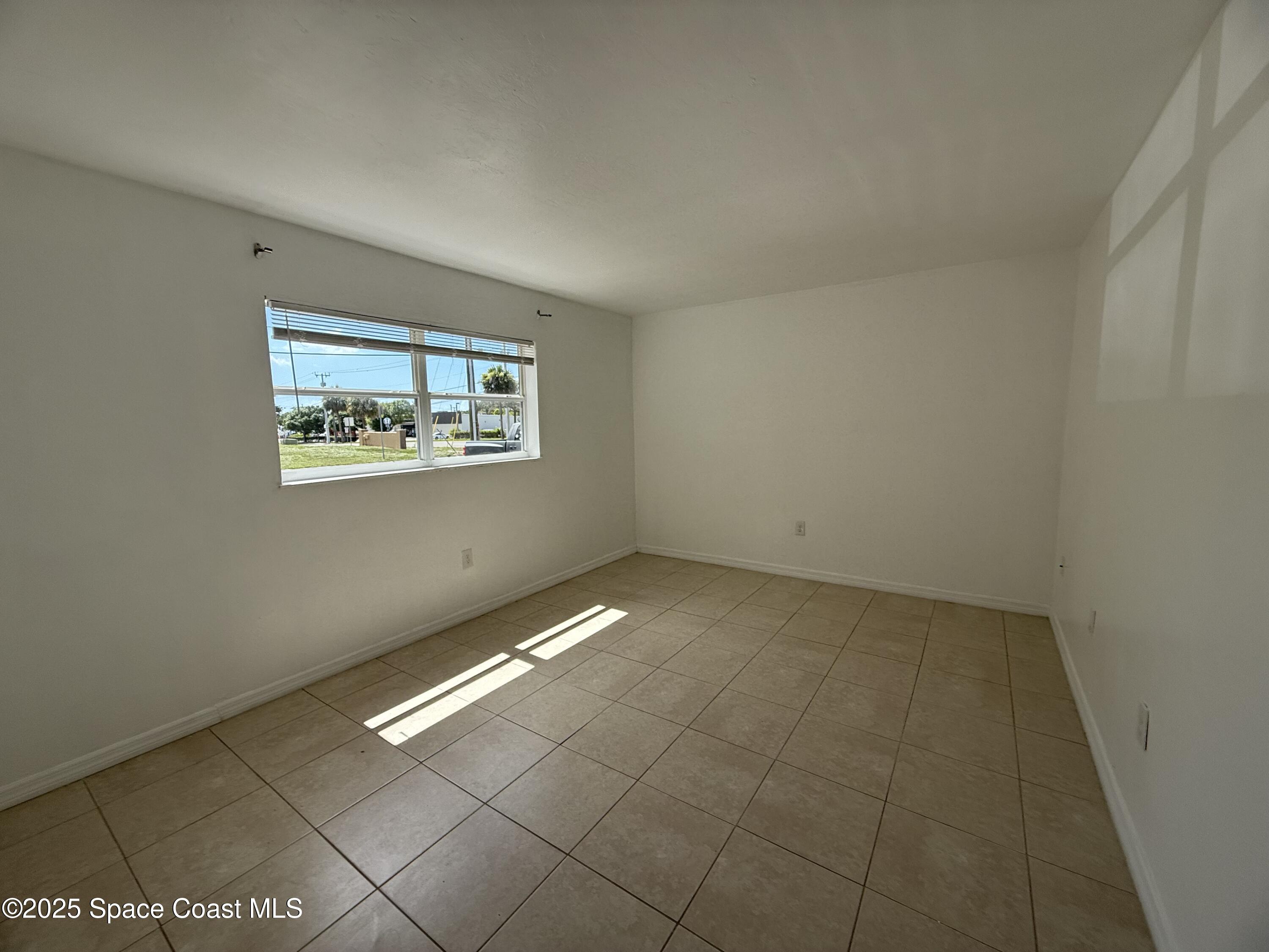 1440 Parkway Drive, Unit 8A Melbourne, FL 32935 - Photo 11 of 21 an empty room with windows