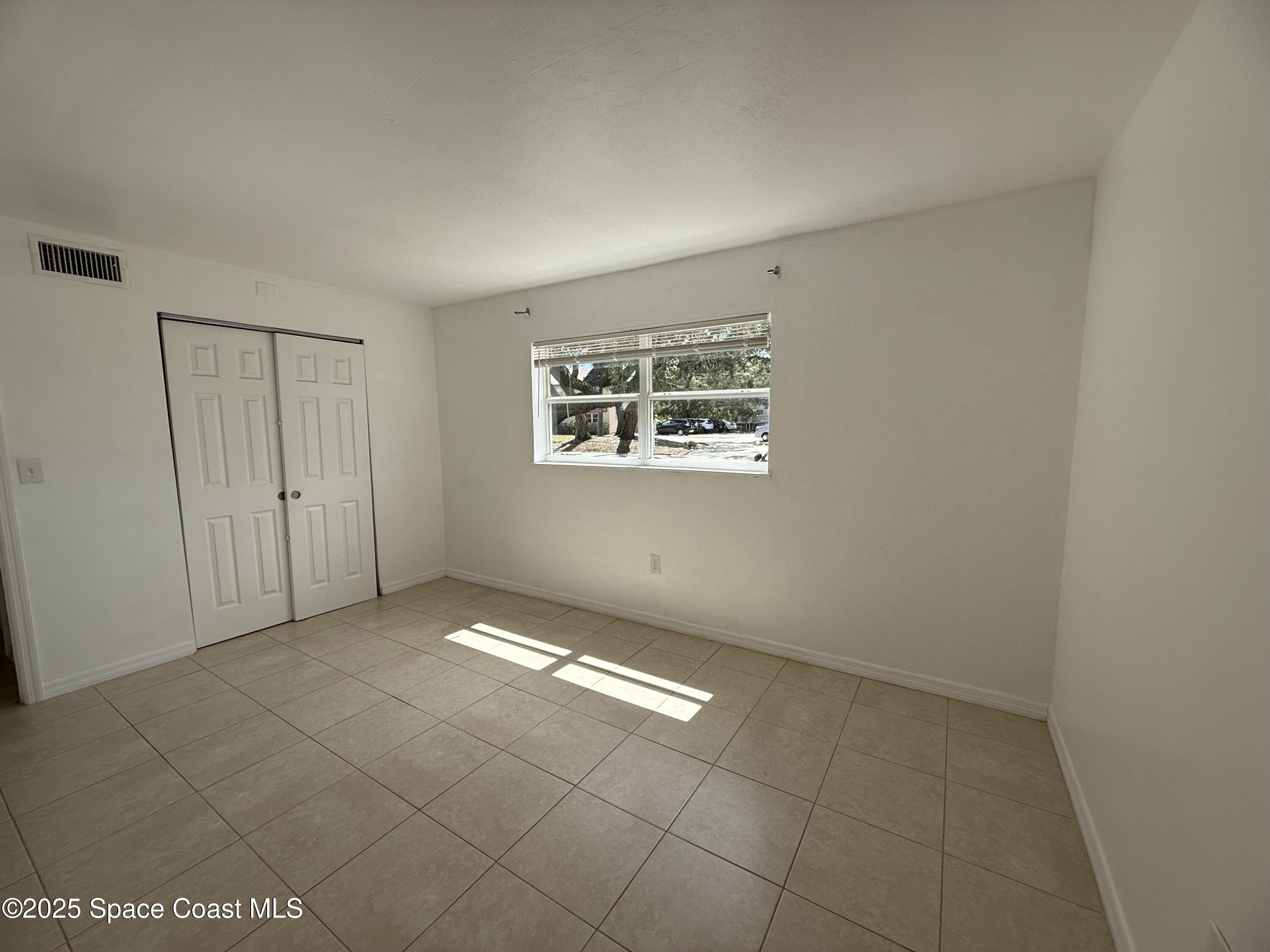 1440 Parkway Drive, Unit 8A Melbourne, FL 32935 - Photo 12 of 21 an empty room with windows