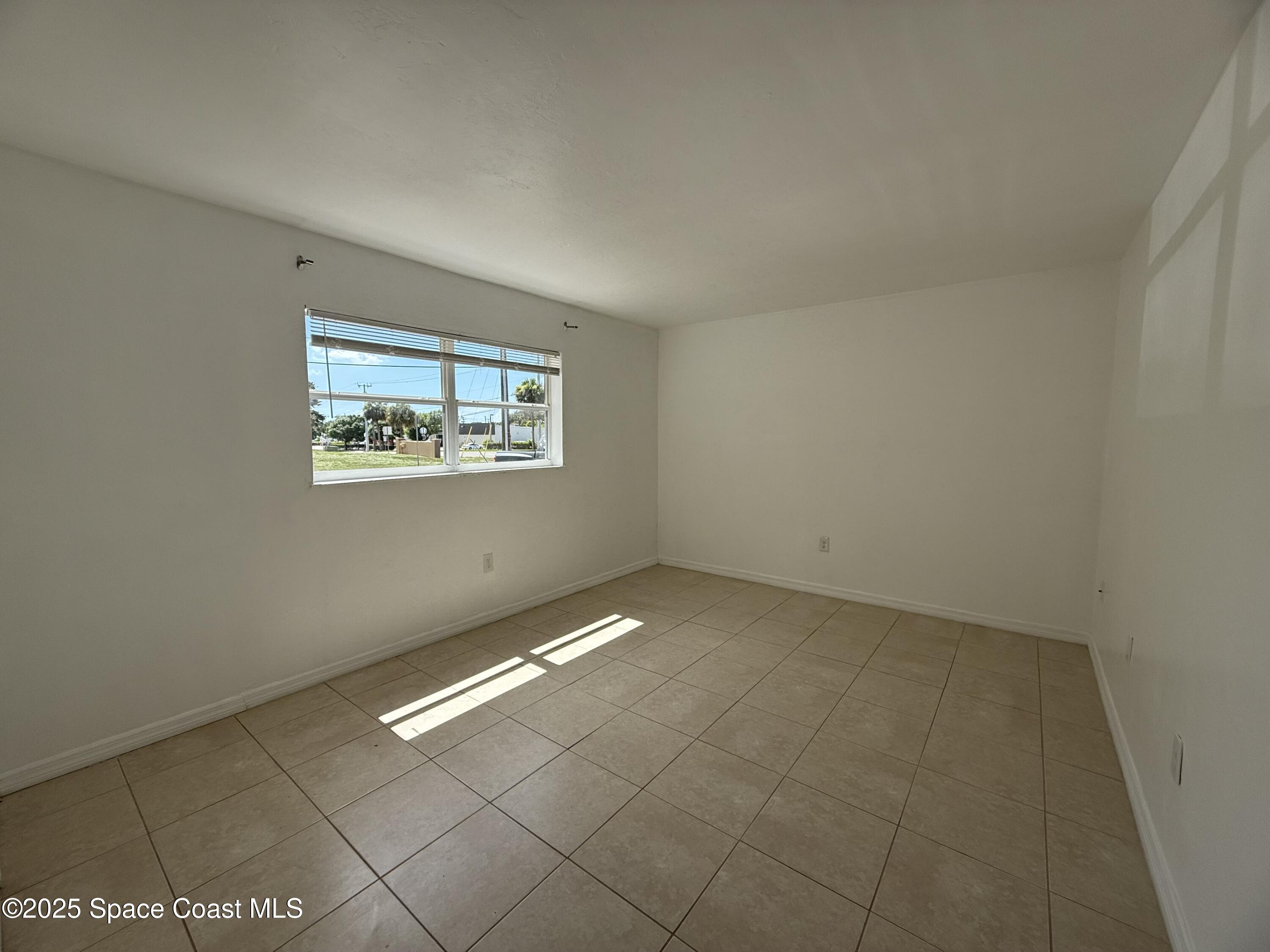 1440 Parkway Drive, Unit 8A Melbourne, FL 32935 - Photo 13 of 21 an empty room with windows