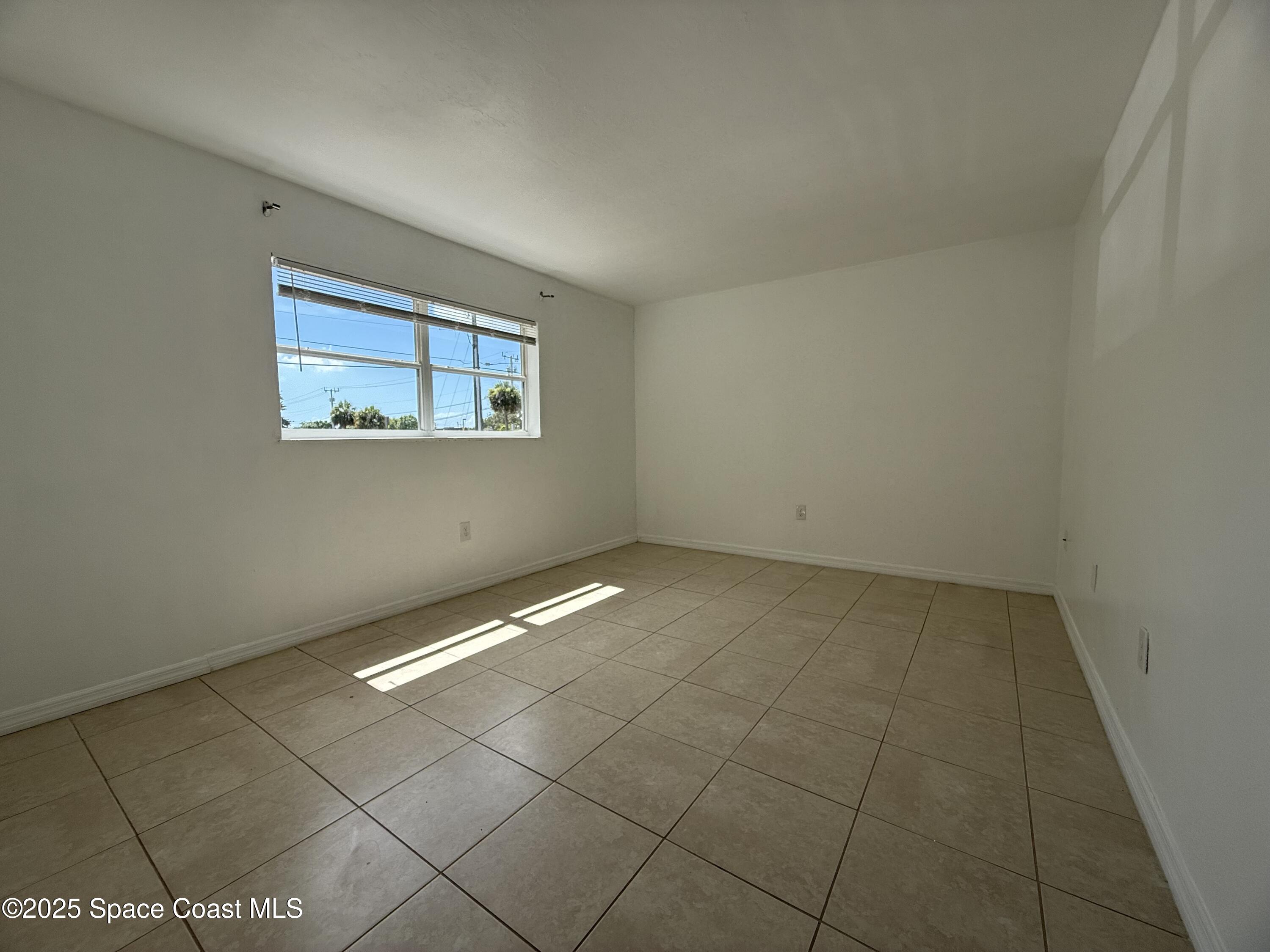 1440 Parkway Drive, Unit 8A Melbourne, FL 32935 - Photo 14 of 21 a view of an empty room with a window