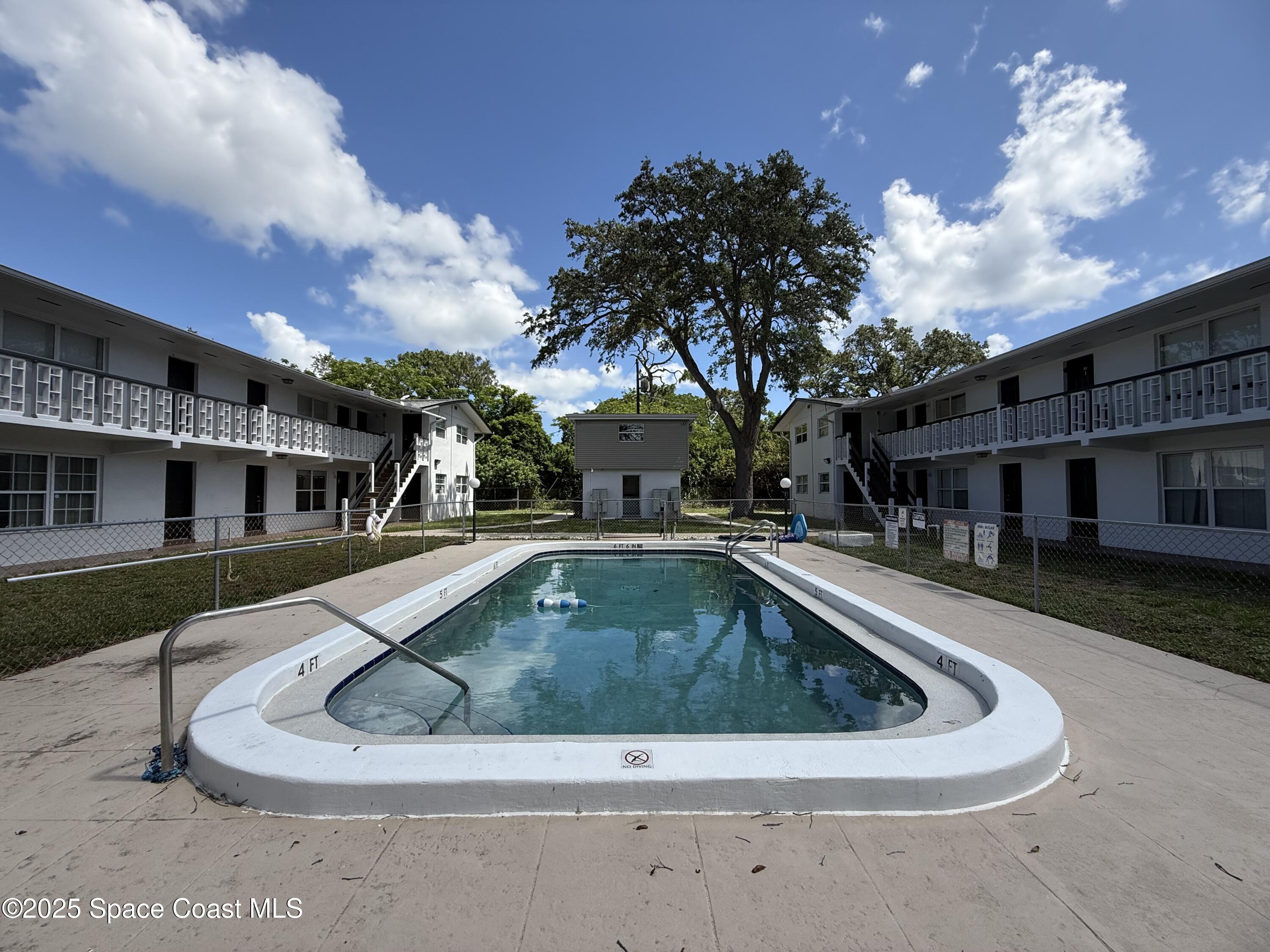 1440 Parkway Drive, Unit 8A Melbourne, FL 32935 - Photo 21 of 21 a view of a house with swimming pool and sitting area