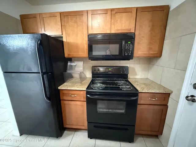 a stove top oven sitting inside of a kitchen