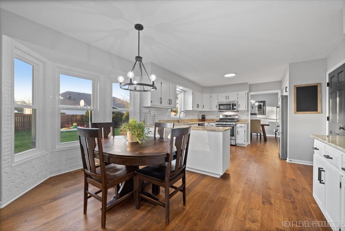 602 Highbury Lane Geneva, IL 60134 - Photo 11 of 28 a dining room with furniture a chandelier and wooden floor