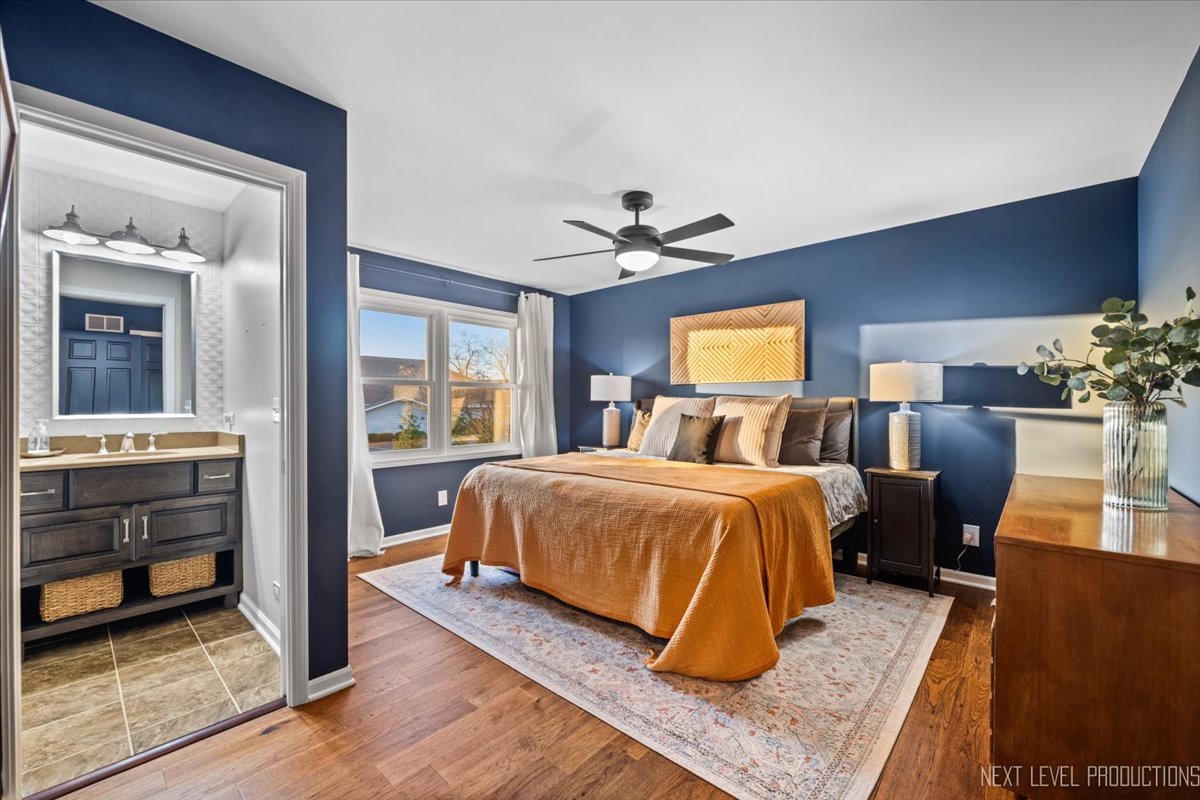 602 Highbury Lane Geneva, IL 60134 - Photo 14 of 28 a spacious bedroom with a bed and wooden floor