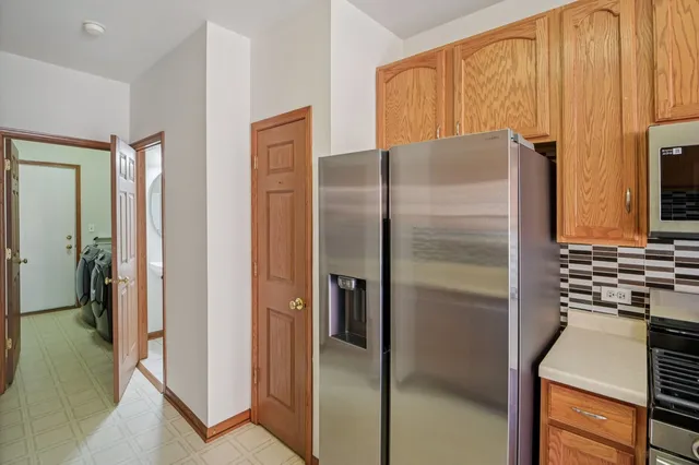 a kitchen with stainless steel appliances granite countertop a refrigerator and a stove
