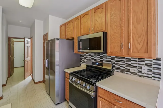 a kitchen with a refrigerator stove and microwave