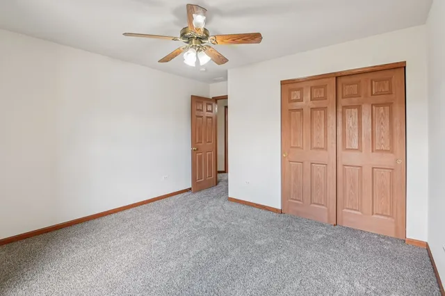 an empty room with chandelier fan