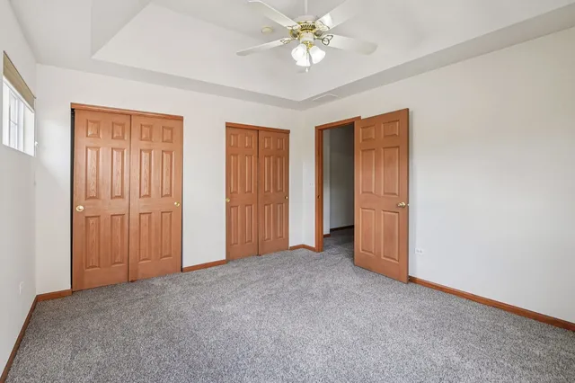 an empty room with a ceiling fan