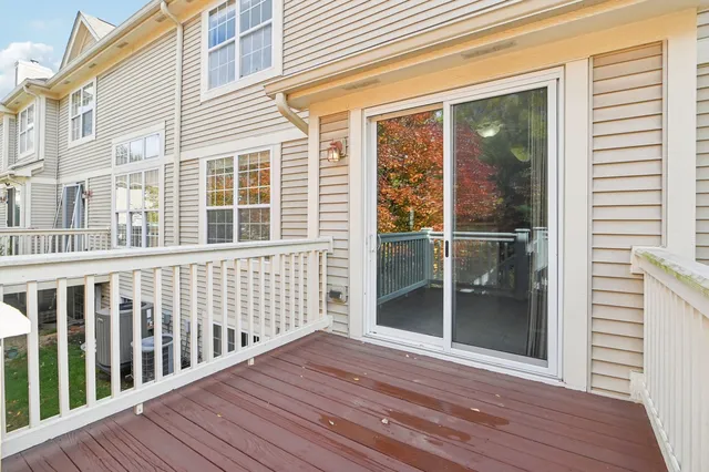 a view of balcony with wooden floor and fence
