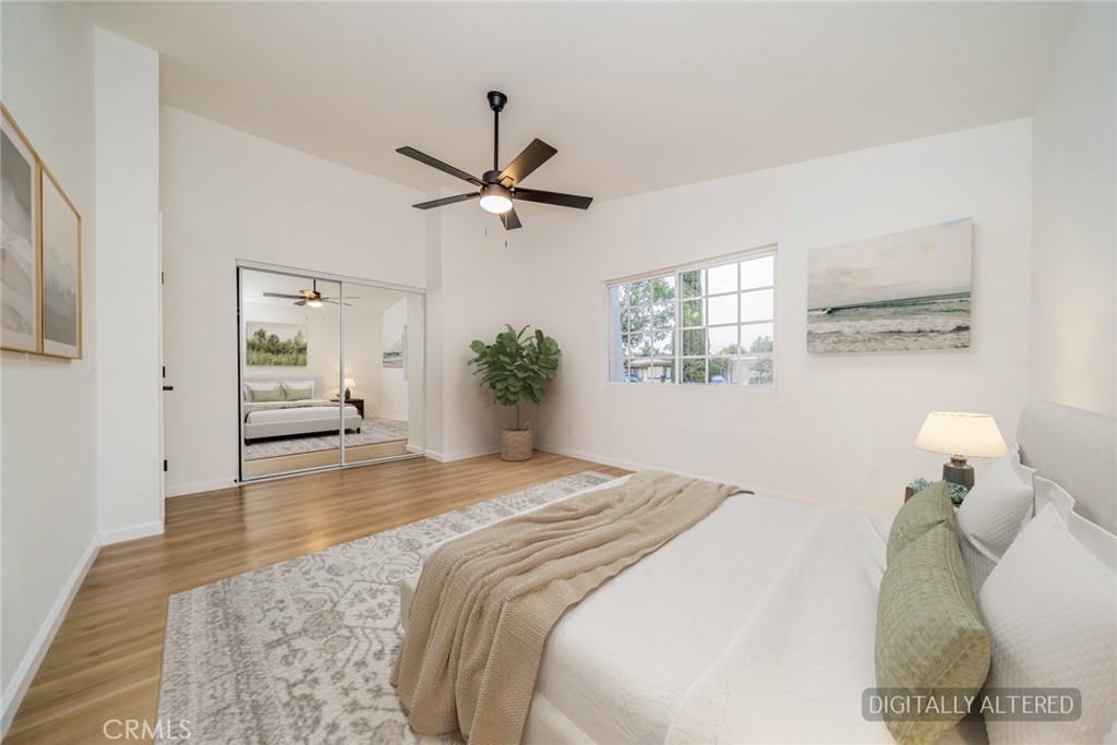 555 North Chestnut Avenue Rialto, CA 92376 - Photo 17 of 33 a bedroom with a large bed and a chandelier