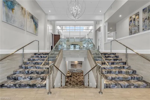 a kitchen with stainless steel appliances kitchen island granite countertop a refrigerator and a stove