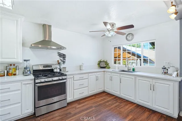 a kitchen with granite countertop a refrigerator and a sink